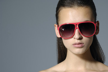 Close up fashion model wearing the big modern sunglasses