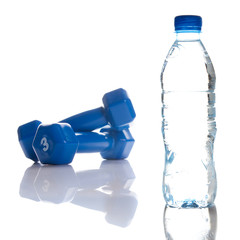 Dumbbells and bottle of fresh water isolated on white