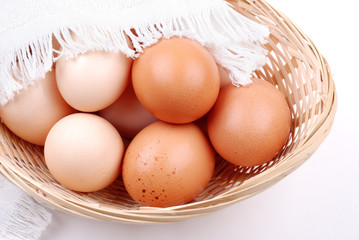 Basket with eggs on white
