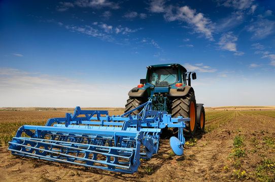 The Tractor - modern farm equipment in field