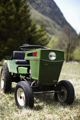 Small green tractor on the field