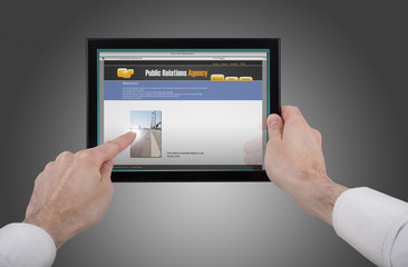 male hand holding a touchpad pc and surfing the web