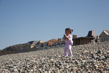 Baby girl playing on the beach