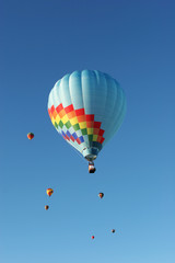Hot air balloons are flying during a festival