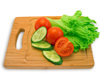 Tomatoes, cucumbers and lettuce on a wooden board