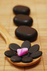 Fototapeta na wymiar spoon with stones for massage