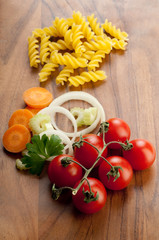 tomatoes and vegetables ingredients with pasta ready to cook