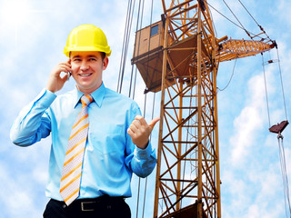 Young architect wearing a protective helmet standing on the buil