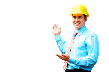 Young architect wearing a protective helmet standing on the buil