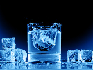Close up view of the glass and ice cubes on black