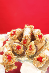 Sicilian filled Cannoli on red