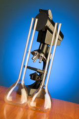 Microscope against blue gradient background
