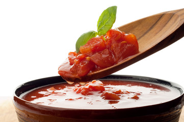 raw tomato pulp with basil over the spoon