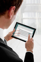 Businessman holding a touchpad pc, writing an e-mail © Robert Lehmann