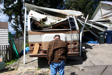 man and damged rv waiting for insurance