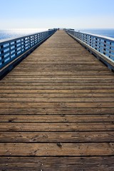 Long wooden Pier before blue sky