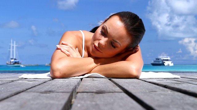 Beautiful woman resting near water at Maldives