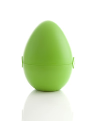 Green egg over white background