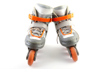 pair of roller skates over white background