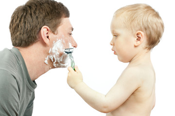 boy shaving father