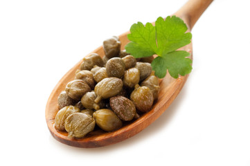 capers with parsley over the spoon