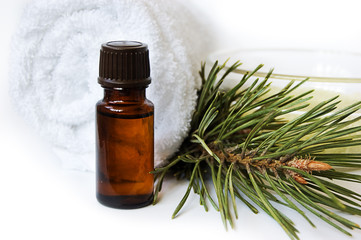 Bottle of fir tree oil and towel