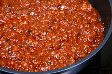 Spaghetti bolognese sauce on a pan on a stove