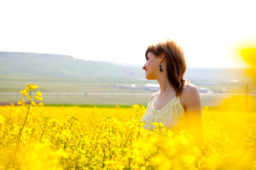 Naklejka na ściany i meble Girl in a rapeseed field