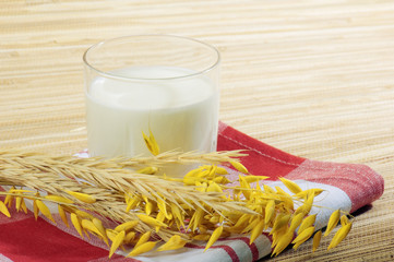 Glass of kefir and wheat ears