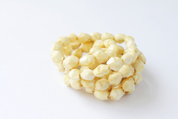 Necklace with yellowish stones on white background
