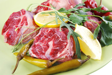 uncooked meat medallion on green