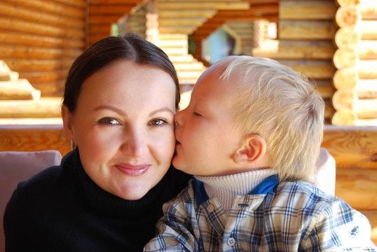 Family portrait - the child kissing mum