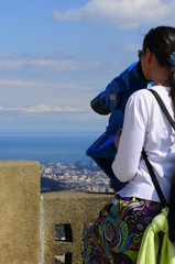Woman looking through a coin operated binoculars