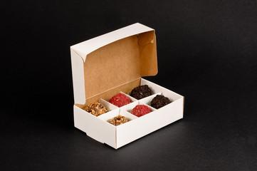 Colored chocolate balls in box, view from the angle