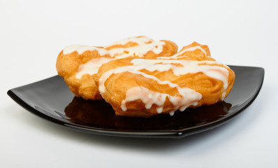 Two pastries filled with custard on plate