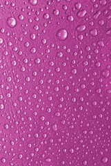 pink water drops on a glass