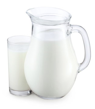 Pitcher and glass of milk on a white background