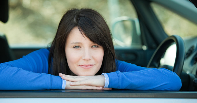 Cute Teen Girl Smiling At The Camera Sitting In Her Car