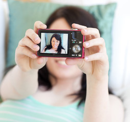 Young woman taking a photo of herself