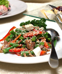 Salad from vegetables with meat and a sesame