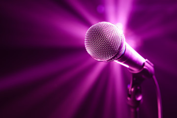 Naklejka premium microphone on stage with purple background
