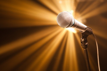 microphone on stage with golden rays