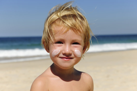 Cute Child With Sunscreen  At The Beach