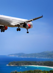 Fototapeta premium Airplane landing on tropical country