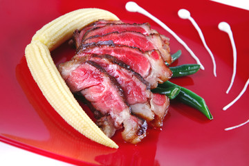 meat served on white with corns