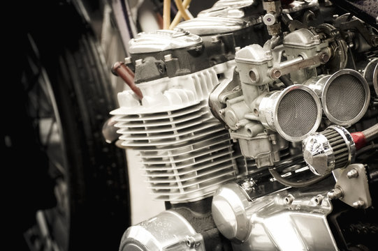 motorcycle carburetor and engine parts closeup