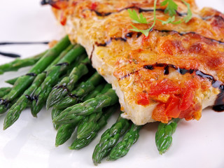 baked fish with vegetables isolated on white background