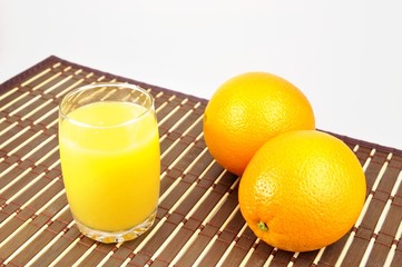 Fresh orange and juice on table cloth