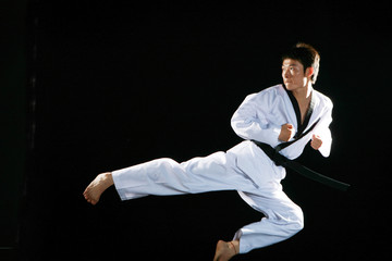 one asian man is playing with taekwondo