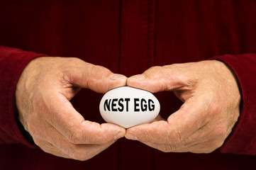 Man holds white egg with NEST EGG written on it